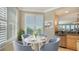 Bright breakfast nook with white table and four chairs, perfect for casual dining at 409 N Point Rd # 501, Osprey, FL 34229