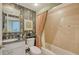 Updated bathroom with granite vanity, tiled shower/tub, and patterned wallpaper at 409 N Point Rd # 501, Osprey, FL 34229