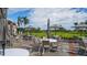 Expansive patio with tables and umbrellas near the green at 409 N Point Rd # 501, Osprey, FL 34229