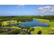 Aerial view of upscale community with golf course, lake, and ocean views at 409 N Point Rd # 501, Osprey, FL 34229