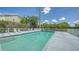 Refreshing community swimming pool with lounge chairs at 16450 Gloria Ln # 105, Nokomis, FL 34275
