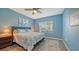 Spacious bedroom with king-size bed and ceiling fan at 16450 Gloria Ln # 105, Nokomis, FL 34275