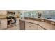 Well-equipped kitchen with stainless steel appliances and white cabinets at 16450 Gloria Ln # 105, Nokomis, FL 34275