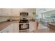 Updated kitchen with stainless steel appliances and white cabinets at 16450 Gloria Ln # 105, Nokomis, FL 34275