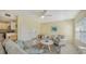 Living room with light colored furniture and a view of kitchen at 16450 Gloria Ln # 105, Nokomis, FL 34275