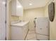 Laundry room with washer, dryer, and extra storage at 16450 Gloria Ln # 105, Nokomis, FL 34275