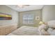 Guest bedroom with a full-size bed and coastal decor at 16450 Gloria Ln # 105, Nokomis, FL 34275