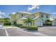 View of a yellow two-story building with attached garages at 16450 Gloria Ln # 105, Nokomis, FL 34275