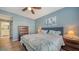 King-size bed, ceiling fan, and ensuite bathroom access at 16450 Gloria Ln # 105, Nokomis, FL 34275