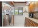 Kitchen features stainless steel refrigerator and granite countertops at 6236 Midnight Pass Rd # 304, Sarasota, FL 34242