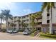 Two-story building with parking and tropical landscaping at 6236 Midnight Pass Rd # 304, Sarasota, FL 34242