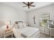 Bright bedroom with a queen-size bed and side table at 308 Cassano Dr, Nokomis, FL 34275