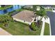 Lovely aerial perspective of private residence showcasing lush landscaping and serene backyard at 310 Lake Tahoe Ct, Englewood, FL 34223