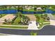 Scenic aerial view of a waterfront home showcasing lush landscaping, a well-manicured lawn, and mature trees at 310 Lake Tahoe Ct, Englewood, FL 34223