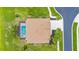 Overhead shot of a private residence featuring a screened-in pool, well-maintained landscaping, and a cozy backyard at 310 Lake Tahoe Ct, Englewood, FL 34223