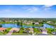Scenic aerial view featuring luxurious waterfront homes, lush landscaping, and a tranquil community lake at 310 Lake Tahoe Ct, Englewood, FL 34223