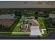 Sunset aerial view of a lovely home with a beautiful lake view, lush landscaping and a three car garage at 310 Lake Tahoe Ct, Englewood, FL 34223