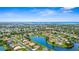 Stunning aerial view showcases a peaceful community with serene lake views and lush green landscapes at 310 Lake Tahoe Ct, Englewood, FL 34223