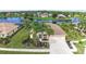 Gorgeous aerial view showcasing a well-maintained home with lush landscaping and lake views in a desirable neighborhood at 310 Lake Tahoe Ct, Englewood, FL 34223