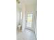 Bright bathroom featuring a toilet and a door to the outdoor lanai and pool area at 310 Lake Tahoe Ct, Englewood, FL 34223