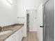 Bright bathroom features a double vanity and a doorway leading to a shower at 310 Lake Tahoe Ct, Englewood, FL 34223