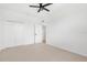 Bright, carpeted bedroom with a spacious closet and easy access to other rooms at 310 Lake Tahoe Ct, Englewood, FL 34223