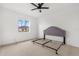 Bright bedroom with a ceiling fan, a large window, and neutral decor offers a serene retreat at 310 Lake Tahoe Ct, Englewood, FL 34223