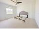 A bedroom featuring a ceiling fan, carpeted floor, window and a bed frame at 310 Lake Tahoe Ct, Englewood, FL 34223