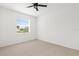 Clean, minimalist bedroom with neutral carpet and a bright, airy atmosphere at 310 Lake Tahoe Ct, Englewood, FL 34223