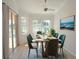 Bright dining room features large windows offering scenic views, plus a modern ceiling fan at 310 Lake Tahoe Ct, Englewood, FL 34223
