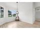 Charming dining room with large windows, stylish light fixture, and ample natural light, perfect for gatherings at 310 Lake Tahoe Ct, Englewood, FL 34223