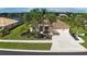 Inviting single-Gathering home with lush landscaping, mature palm trees, and a well-maintained front yard at 310 Lake Tahoe Ct, Englewood, FL 34223