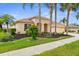 Charming single-Gathering home boasts a well-manicured lawn with lush landscaping and mature trees at 310 Lake Tahoe Ct, Englewood, FL 34223