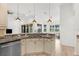 Modern kitchen with granite counters, stainless steel appliances, and open layout to dining area at 310 Lake Tahoe Ct, Englewood, FL 34223