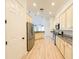 Kitchen with stainless steel appliances, cream colored cabinets, and hardwood floors at 310 Lake Tahoe Ct, Englewood, FL 34223
