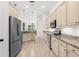 Spacious kitchen with stainless steel appliances, ample cabinetry, and granite countertops at 310 Lake Tahoe Ct, Englewood, FL 34223