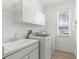 Convenient laundry room with sink, washer, dryer, and ample cabinet space at 310 Lake Tahoe Ct, Englewood, FL 34223
