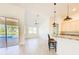 Bright living room showcasing an open floor plan, natural light, and a kitchen with granite counters at 310 Lake Tahoe Ct, Englewood, FL 34223