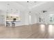 Spacious open-concept living area with hardwood floors seamlessly connecting the kitchen and dining spaces at 310 Lake Tahoe Ct, Englewood, FL 34223