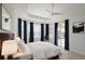 Bright bedroom featuring tray ceilings, large windows, dark curtains, and access to pool at 310 Lake Tahoe Ct, Englewood, FL 34223