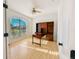 Home office featuring hardwood floors, a large window, and built-in shelving at 310 Lake Tahoe Ct, Englewood, FL 34223
