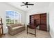 Bright home office with built-in bookshelves, desk, and comfortable seating area at 310 Lake Tahoe Ct, Englewood, FL 34223