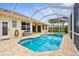 Inviting screened pool and spa area with brick pavers offers a relaxing outdoor experience at 310 Lake Tahoe Ct, Englewood, FL 34223