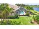 A beautiful screened-in pool with spa is surrounded by lush landscaping offering a private oasis at 310 Lake Tahoe Ct, Englewood, FL 34223