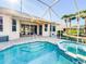 Sparkling pool and spa area with screened-in lanai, brick pavers, and a sunny backyard at 310 Lake Tahoe Ct, Englewood, FL 34223
