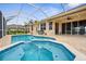 Beautiful in-ground pool and jacuzzi, with screened enclosure and outdoor entertaining area at 310 Lake Tahoe Ct, Englewood, FL 34223