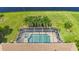 Aerial view of private screened pool and spa surrounded by lush landscaping and overlooking tranquil waterfront at 310 Lake Tahoe Ct, Englewood, FL 34223
