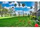 Lush green lawn with palm trees and red flowers at 2320 Terra Ceia Bay Blvd # 203, Palmetto, FL 34221