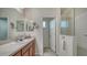 Bright bathroom with a walk-in shower and double vanity at 308 Cassano Dr, Nokomis, FL 34275