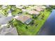 Aerial view of a house with pool, situated on a lakefront lot in a quiet community at 310 Lake Tahoe Ct, Englewood, FL 34223